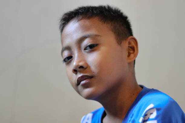 south east asian kid potrait with blue jersey