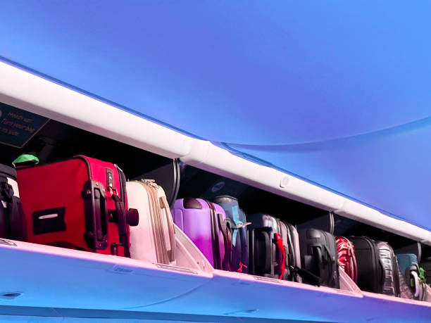 istock luggage in overhead bin on airplane 1716184005