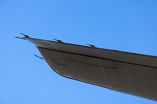 Wing tip of passenger jet against clear blue sky