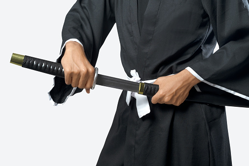 Samurai warrior gripping the sword isolated over white background