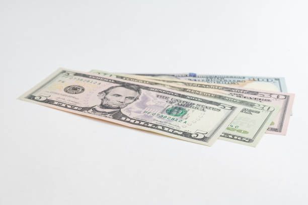 istock 5, 20, 50, 100 dollars banknotes at different angles. Close up of dollars on white background. 1716222944