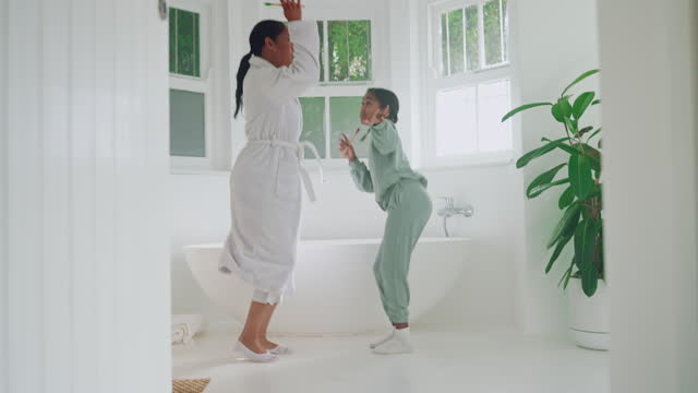 Play, kid or mother dancing in bathroom grooming or cleaning in happy family home together. Dancer, energy or mom with an excited girl child bonding to fun music in morning routine for wellness