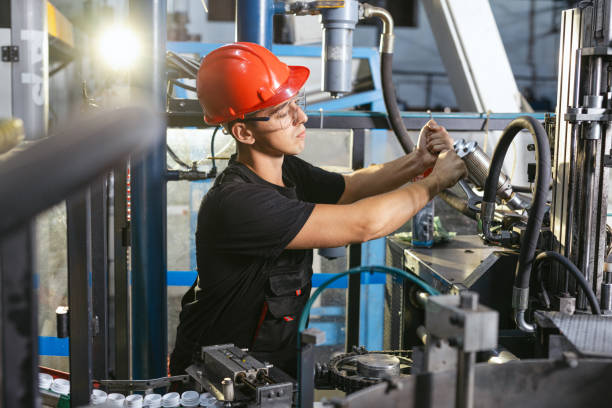 istock Factory worker working in industrial building indoor. Man fixing machines, checking work process, fixing techniciall problems 1716319353