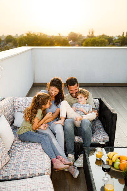 istock Happy family having fun on a patio at sunset. 1716348152