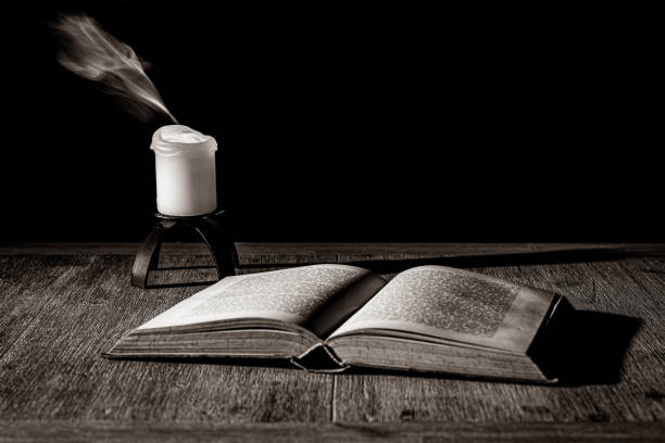 The old Book with a Candle stock photo