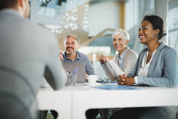 istock Happy entrepreneurs talking during a constructive meeting in the office. 1716365330