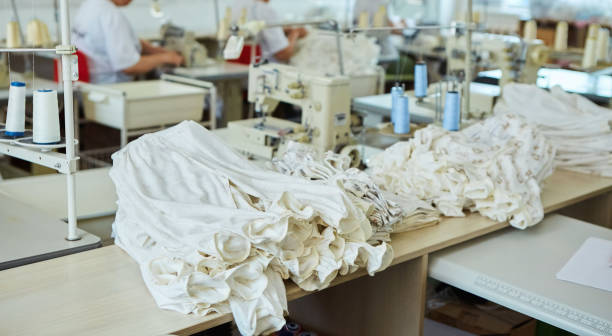 istock Industrial sewing production or atelier. A stack of fabric that requires sewing. The process of creating ready-made clothing models. 1716380020