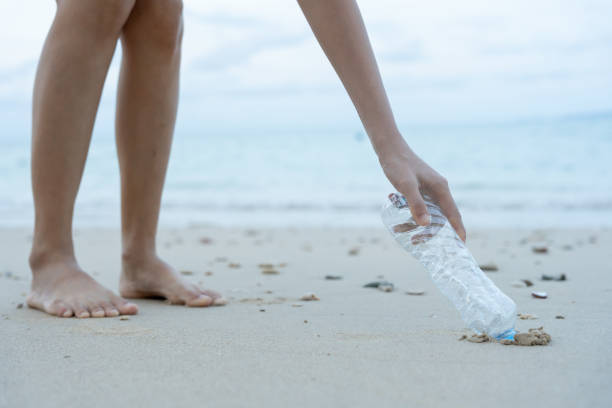 istock Save ocean. Volunteer pick up trash garbage at the beach and plastic bottles are difficult decompose prevent harm aquatic life. Earth, Environment, Greening planet, reduce global warming, Save world 1716380102