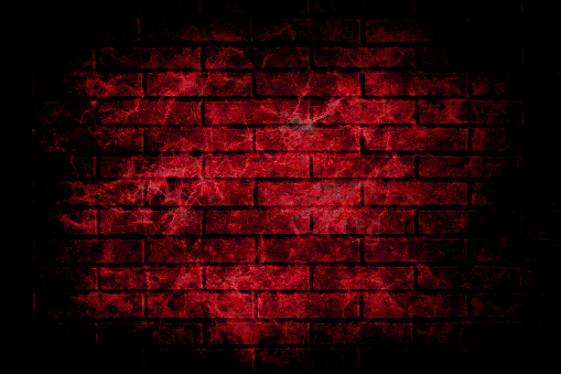 Horizontal illustration of a bright maroon coloured brick wall with rectangular blocks in a textured grungy messy vignetted backgrounds. The wall is rough, uneven, empty and blank with no text and no people and copy space.