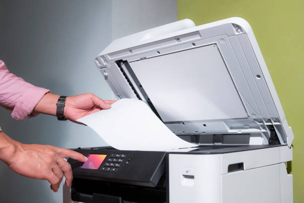 istock office worker prints paper on a multifunction laser printer in home office documents or paperwork. Secretary work. Print technology. Photocopy. 1716380273