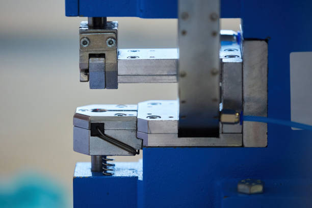 istock Industrial sewing production or atelier. A machine for installing rivets or buttons on clothes. 1716387645