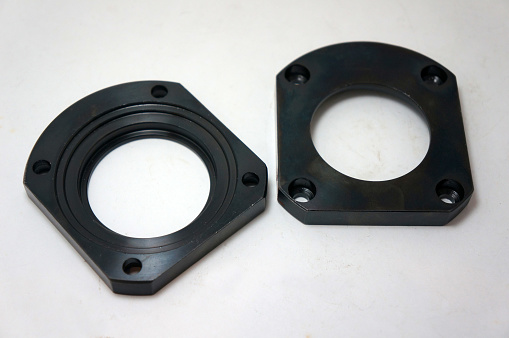 Black steel face flange part manufacturing with CNC machine.