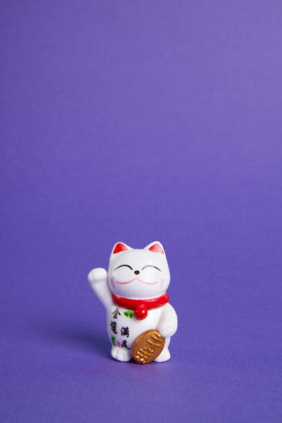 istock a trendy Maneki-neko plastic cat on violet background 1716390577