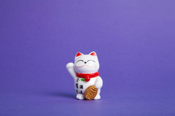 istock a trendy Maneki-neko plastic cat on violet background 1716390991