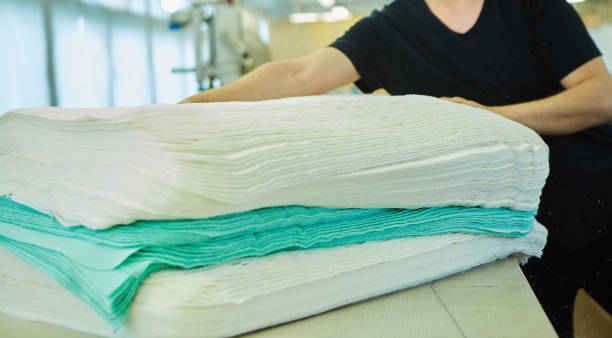 istock Industrial sewing production. A stack of fabrics for sewing clothes. Green and white material. 1716393149