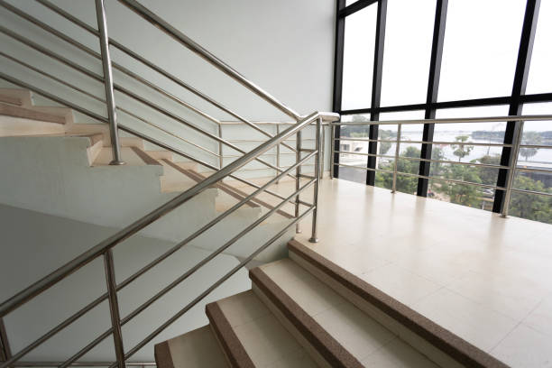 istock Empty stairs with metal handrails and windows in  modern interior building 1716398568