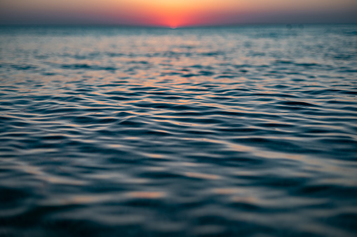 Close up of sea surface on sunset. Water background. High quality photo