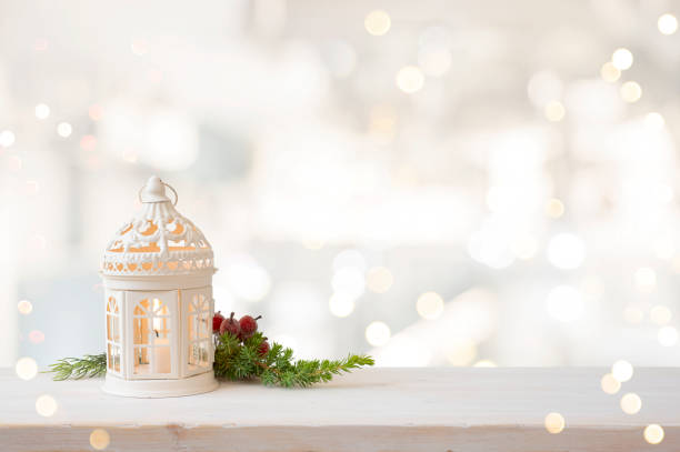 istock Christmas lantern with fir branch on table over defocused background 1716401895