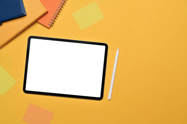 istock Digital tablet, stylus pen, notebook and sticky notes on yellow background. Top view ,flat lay 1716437392