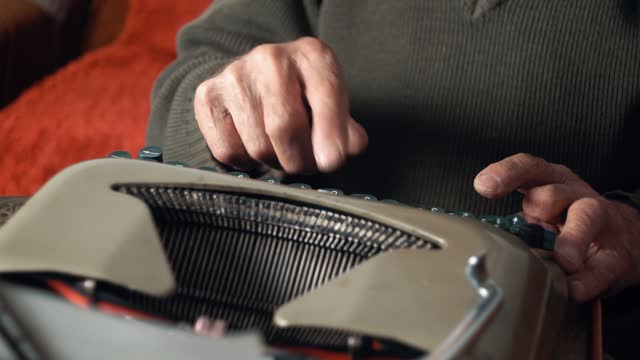 Senior Man Typing On The Typewriter At Home