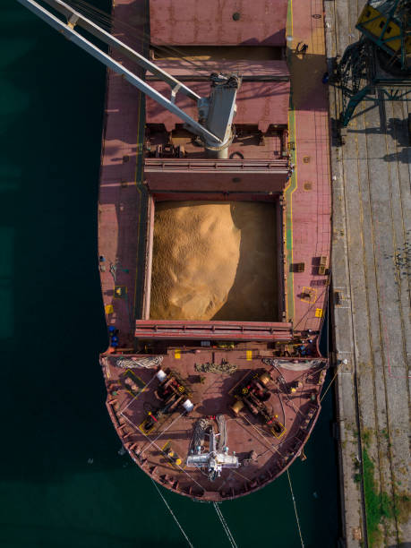 istock cargo ship or bulk carrier loaded to the brim with grain is preparing for departure, working sailors on deck are completing work, aerial view 1716453069