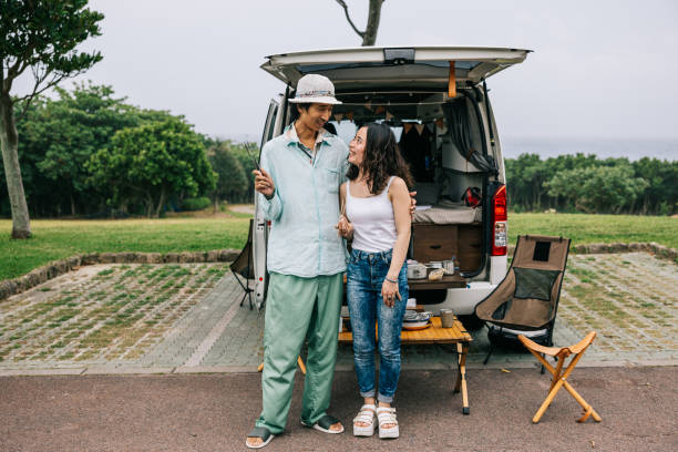 istock Happy couple looking at each other behind their van 1716460137