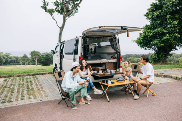 istock Japanese friends having a lively conversation while living vanlife 1716460139