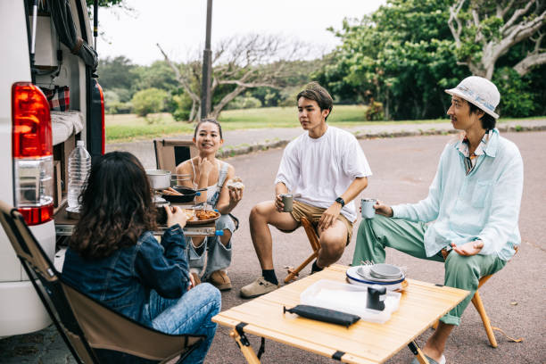 istock Japanese friends having lunch break behind their campervan 1716460157