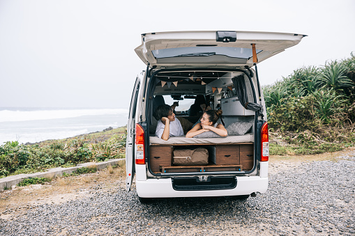 Japanese couple on a roadtrip with their self-built campervan, enjoying the freedom of vanlife.