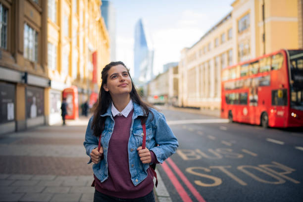 Happy female tourist amiring the beauty of London city.