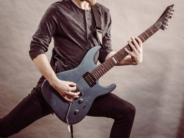 istock Male hands playing electric guitar 1716465603