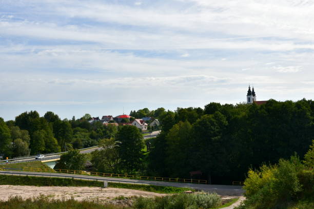 istock A view from a tall hill with some dense forests and moors visible in the distance, together with a church, small village, power pylons, and a Polish flag seen on a sunny summer day in Poland 1716479053