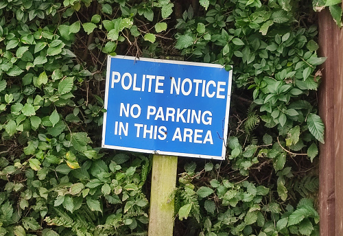 polite no parking sign at street of glasgow scotland england UK