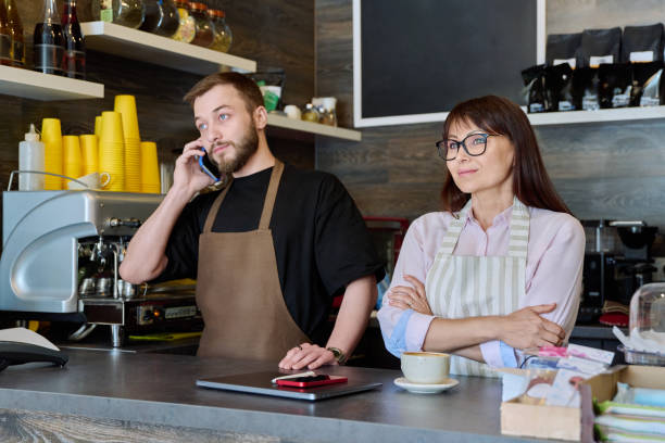 istock Team male and woman talking, working, using phone, coffee shop 1716494435