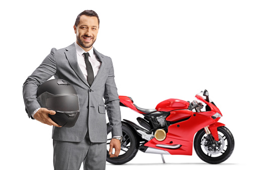 Businessman with a red bike holding a helmet and posing isolated on white background