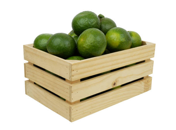 istock Green oranges in wooden box isolated on white 1716500582