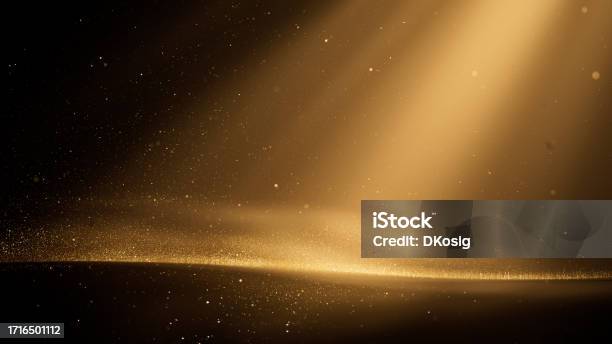 Glittering Gold Particles And Light Beams Abstract Background Christmas Award Celebration Luxury Glitter Stock Photo - Download Image Now