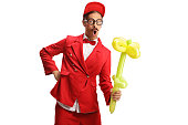 Entertainer holding a yellow flower balloon