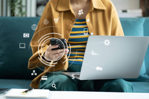 istock women working with smart phone and laptop and digital tablet computer in office with digital marketing media in virtual icon. 1716505146