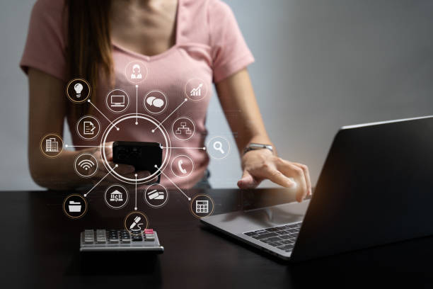 istock business women using laptop and smart phone and digital tablet computer with digital marketing media  in virtual icon network diagram office in morning light. 1716505149