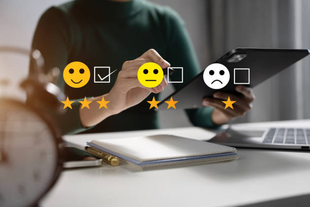istock Woman holding a digital tablet with checkboxes rating smiley faces excellent for Satisfaction Survey, Happy Client Customer Experience concept. 1716505166