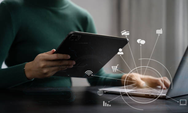 istock business women using laptop and smart phone and digital tablet computer with digital marketing media  in virtual icon network diagram office. 1716505168