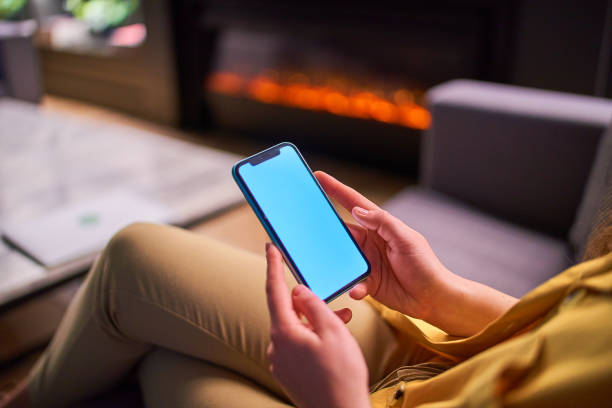 istock Female holding phone with white screen blank. Mockup smartphone 1716516093