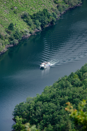 view of a boat sailing on the Sil River, Ribeira Sacra. Galicia, Spain. Heritage world site.