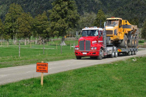 A 30 ton dump truck leaves a construction site in Westland