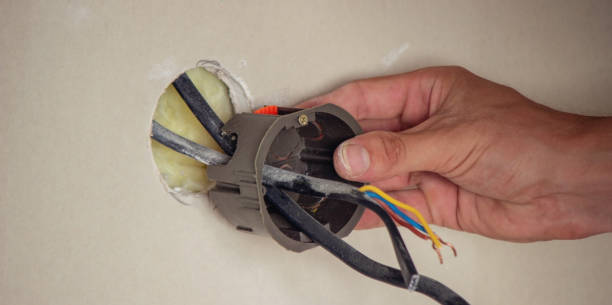 istock an electrician puts sockets in a plasterboard wall. . 1716553162