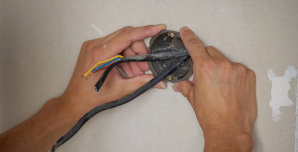 istock an electrician puts sockets in a plasterboard wall. . 1716553164
