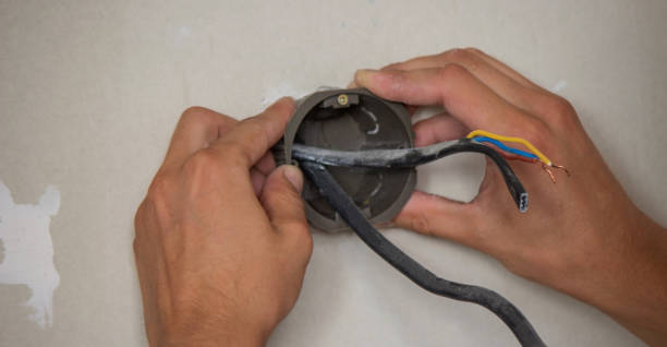 istock an electrician puts sockets in a plasterboard wall. . 1716553170