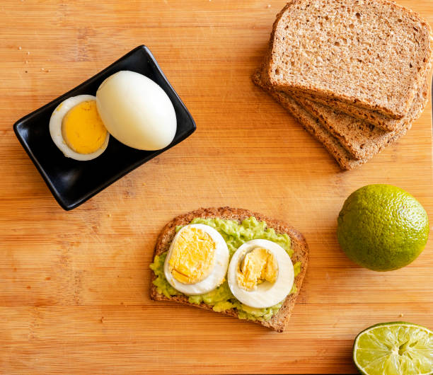 istock avocado toast topped with a perfectly boiled egg, presented on a rustic wooden board 1716555469