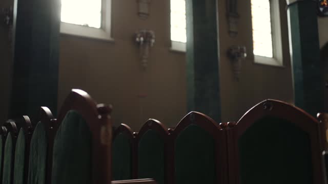 Religion concept. Green seats in catholic church. Slow motion footage.